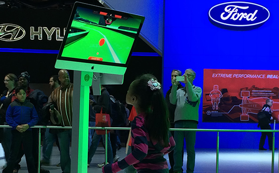 The Ford Ecboboost Challenge game being played by children at the North American International Auto Show in Detroit 2014
