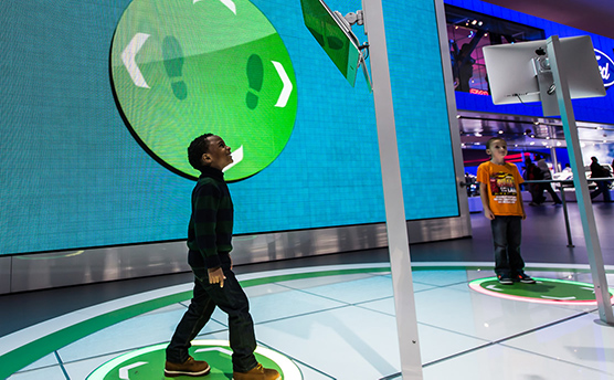 The Ford Ecboboost Challenge game being played by children at the North American International Auto Show in Detroit 2014